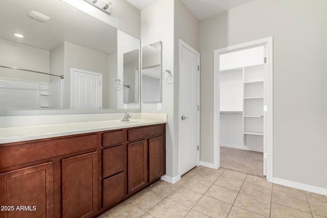 full bath featuring vanity, tile patterned floors, and baseboards