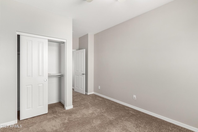 unfurnished bedroom featuring a closet, carpet floors, and baseboards