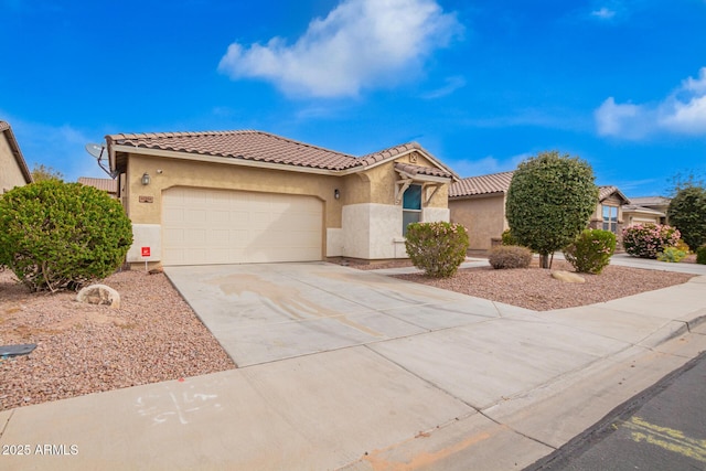 mediterranean / spanish house featuring stucco siding, a garage, driveway, and a tile roof