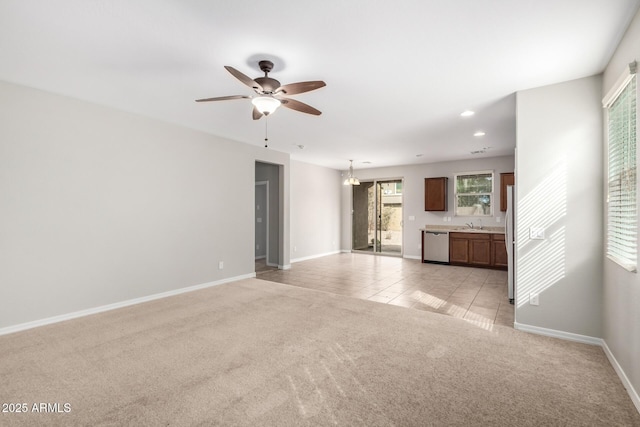 unfurnished living room with recessed lighting, light tile patterned flooring, baseboards, light colored carpet, and ceiling fan