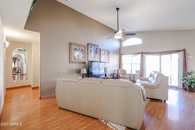 living room with light wood-type flooring, ceiling fan, and lofted ceiling