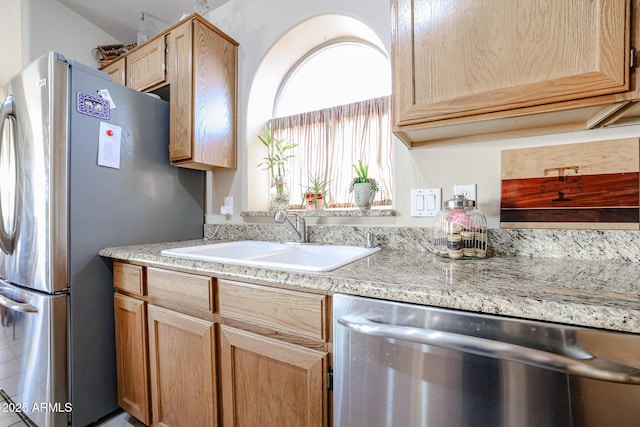 kitchen featuring sink, light brown cabinets, and stainless steel appliances