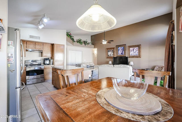 tiled dining room with ceiling fan