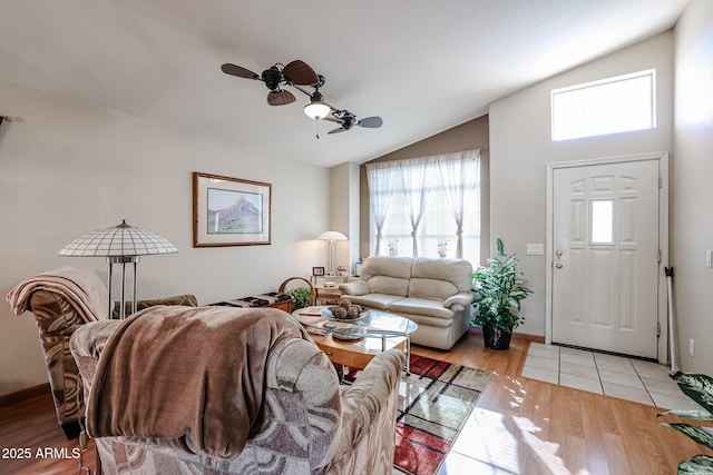 living room with light wood-type flooring, ceiling fan, and lofted ceiling