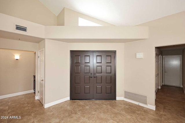 tiled entrance foyer with high vaulted ceiling