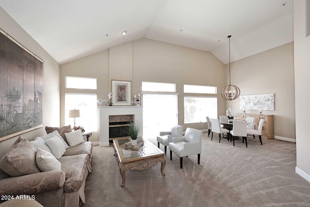 living room featuring carpet, high vaulted ceiling, and a notable chandelier