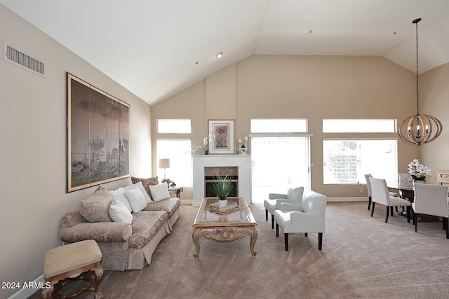 carpeted living room with a chandelier and lofted ceiling