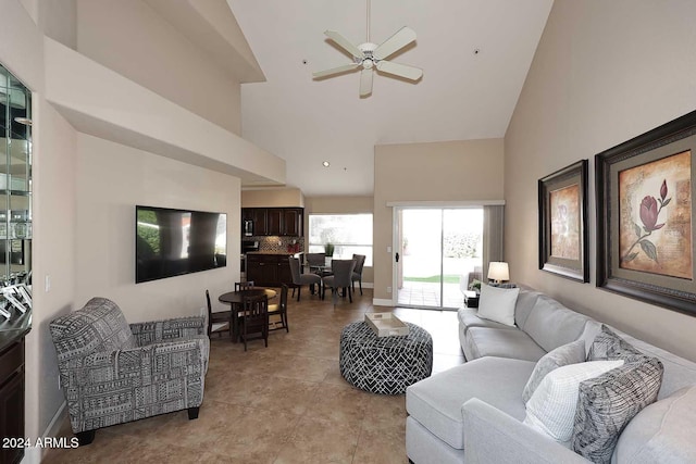 tiled living room featuring high vaulted ceiling and ceiling fan