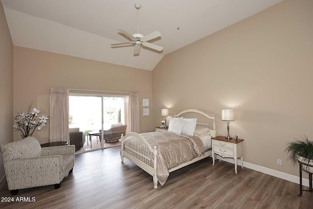 bedroom with access to exterior, dark hardwood / wood-style floors, ceiling fan, and lofted ceiling