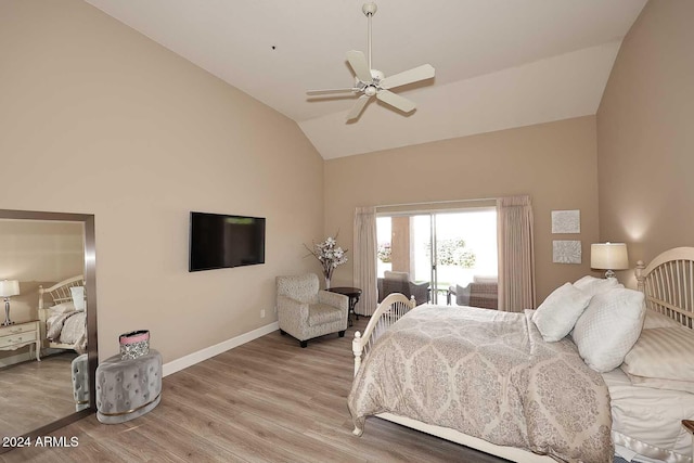 bedroom featuring ceiling fan, light hardwood / wood-style floors, and vaulted ceiling