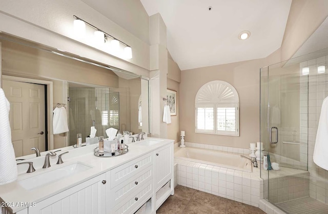 bathroom featuring tile patterned flooring, vanity, lofted ceiling, and shower with separate bathtub