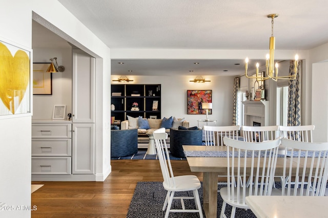 dining space with wood finished floors and a chandelier