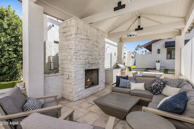 view of patio with an outdoor living space with a fireplace, a grill, and ceiling fan