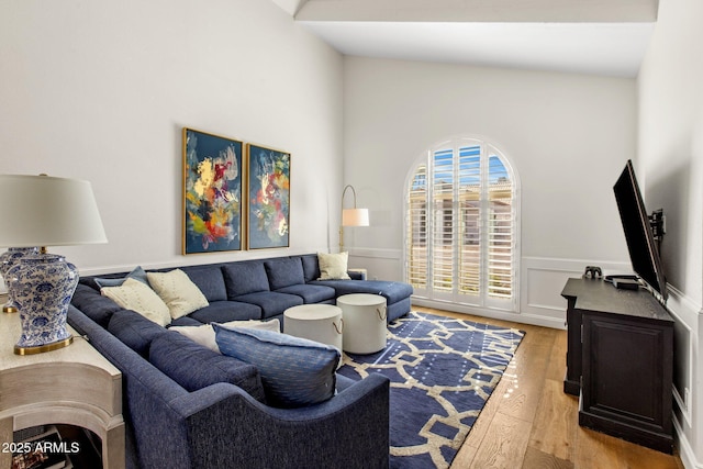 living area with a wainscoted wall and light wood-style flooring