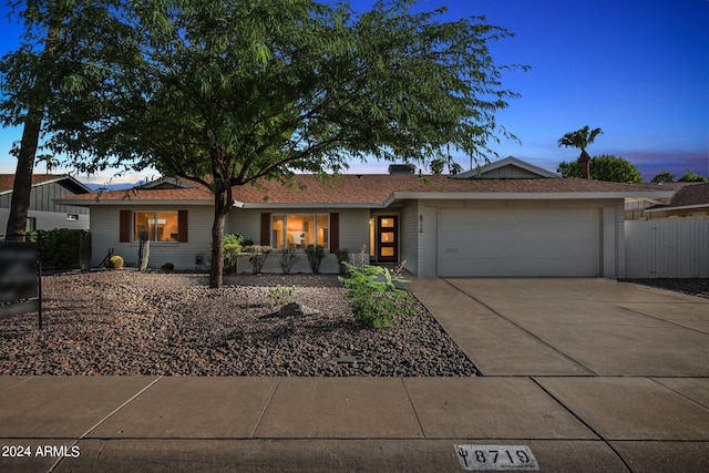 ranch-style home featuring a garage