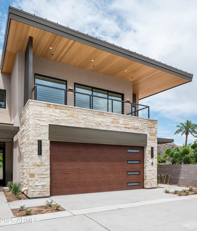 garage with fence and driveway