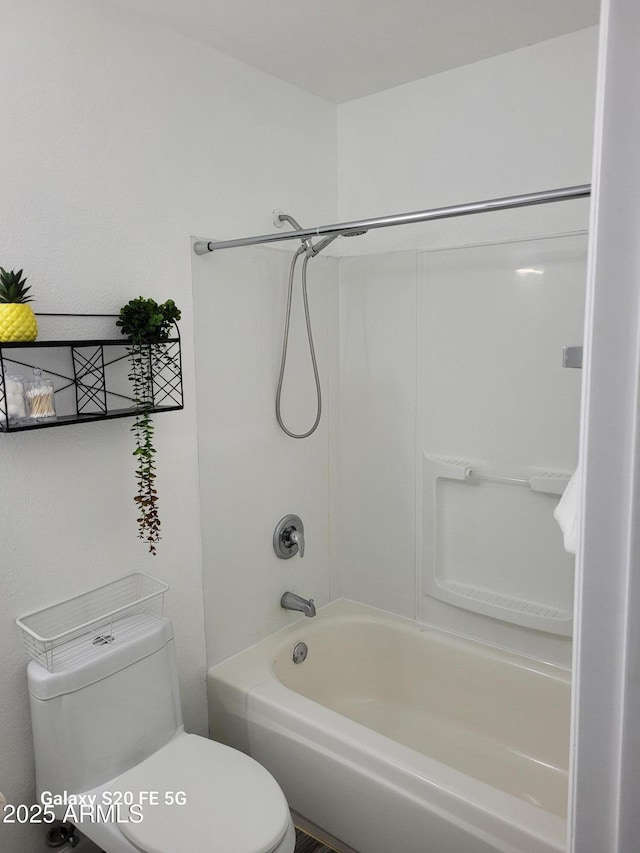 bathroom featuring shower / bathtub combination and toilet