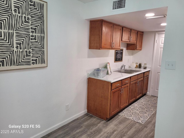 kitchen featuring dark hardwood / wood-style floors and sink