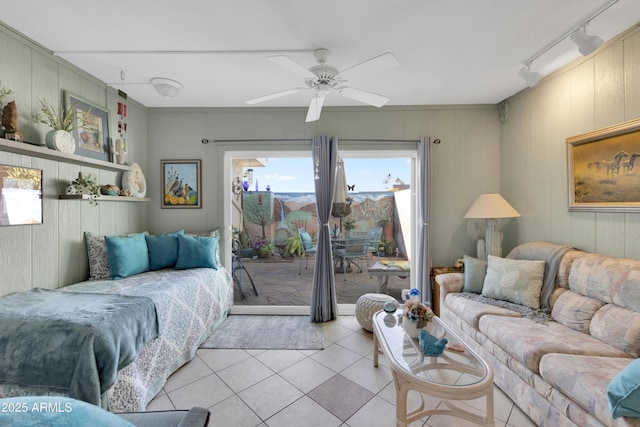 tiled living room with ceiling fan and wooden walls