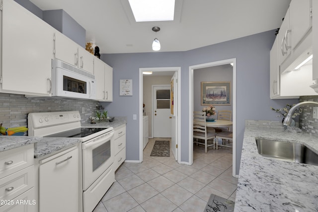 kitchen featuring white cabinetry, pendant lighting, white appliances, decorative backsplash, and light tile patterned flooring