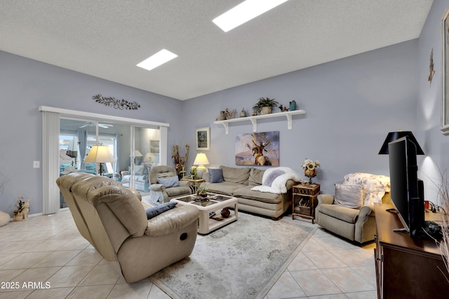 living room featuring a textured ceiling, ceiling fan, and light tile patterned flooring