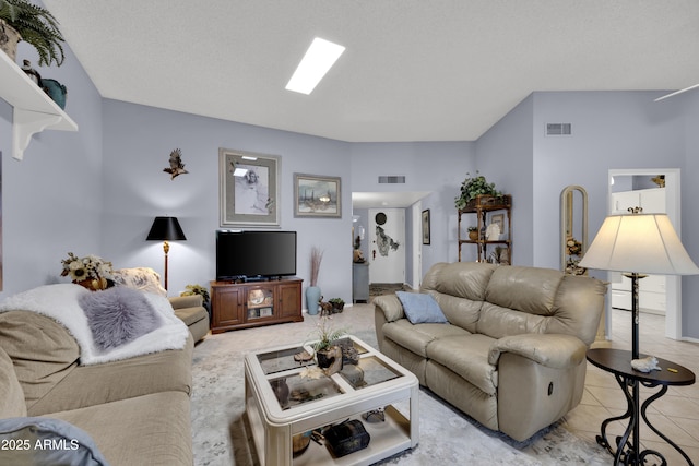 living room featuring light tile patterned floors and a textured ceiling