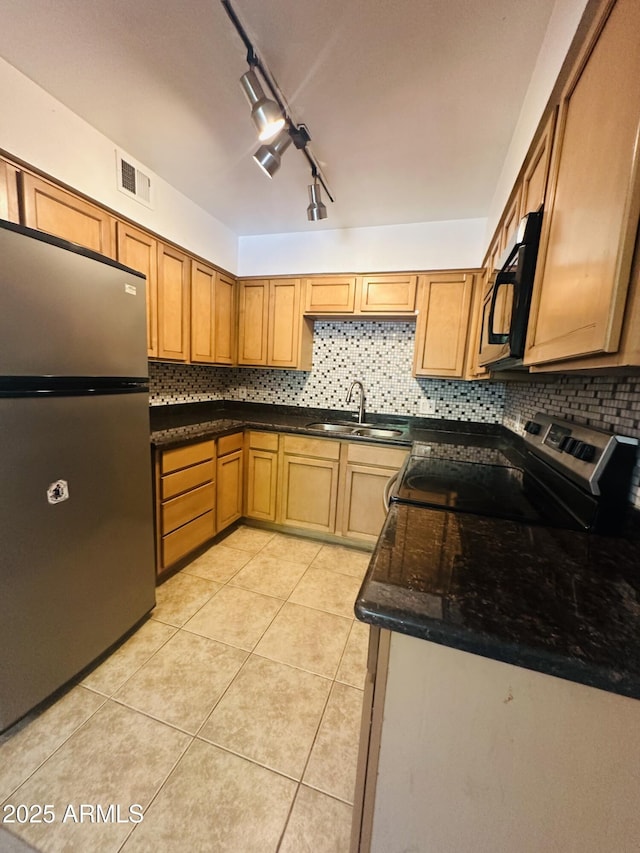1702 W Tuckey Ln Unit 116, Phoenix, AZ 85015 - kitchen featuring stainless steel appliances, decorative backsplash, and light tile patterned floors