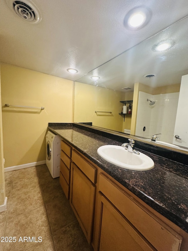 1702 W Tuckey Ln Unit 116, Phoenix, AZ 85015 - bathroom featuring washer / dryer, tile patterned floors, vanity, and a shower