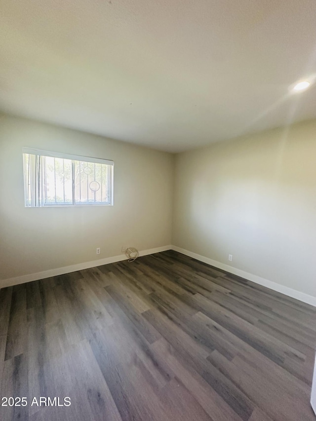 1702 W Tuckey Ln Unit 116, Phoenix, AZ 85015 - empty room with dark wood-style flooring and baseboards