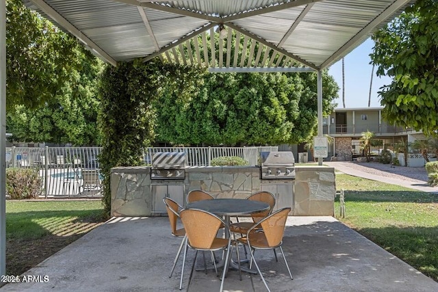 1702 W Tuckey Ln Unit 116, Phoenix, AZ 85015 - view of patio / terrace featuring exterior kitchen and outdoor dining area