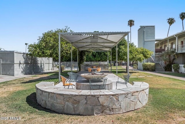 1702 W Tuckey Ln Unit 116, Phoenix, AZ 85015 - view of property's community with exterior kitchen, a yard, and stairs