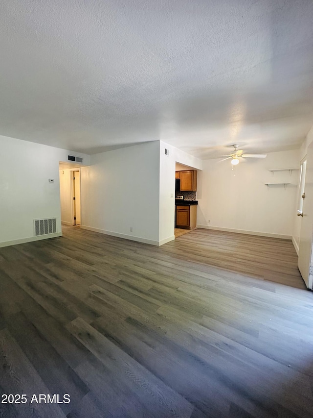 1702 W Tuckey Ln Unit 116, Phoenix, AZ 85015 - unfurnished living room with a ceiling fan, wood finished floors, and a textured ceiling