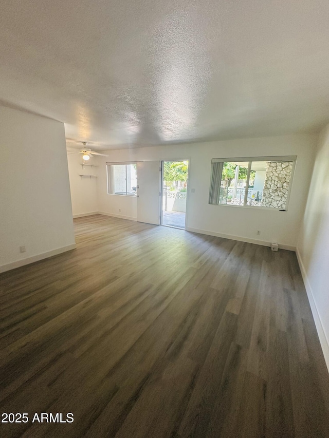 1702 W Tuckey Ln Unit 116, Phoenix, AZ 85015 - unfurnished living room with wood finished floors, a textured ceiling, and a ceiling fan