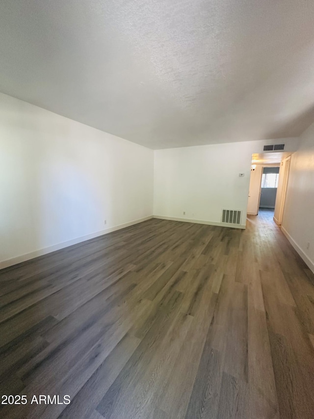 1702 W Tuckey Ln Unit 116, Phoenix, AZ 85015 - empty room with dark wood-style flooring and a textured ceiling