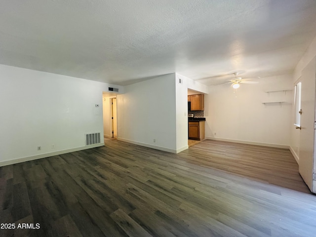 1702 W Tuckey Ln Unit 116, Phoenix, AZ 85015 - unfurnished living room with a ceiling fan, wood finished floors, and a textured ceiling