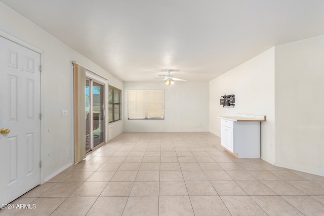 unfurnished living room with ceiling fan and light tile patterned floors