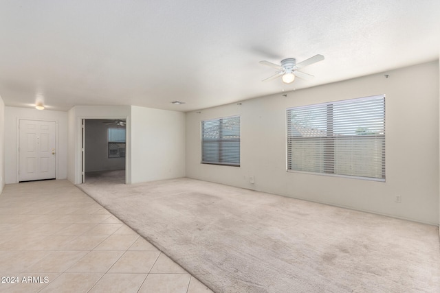 tiled empty room with ceiling fan