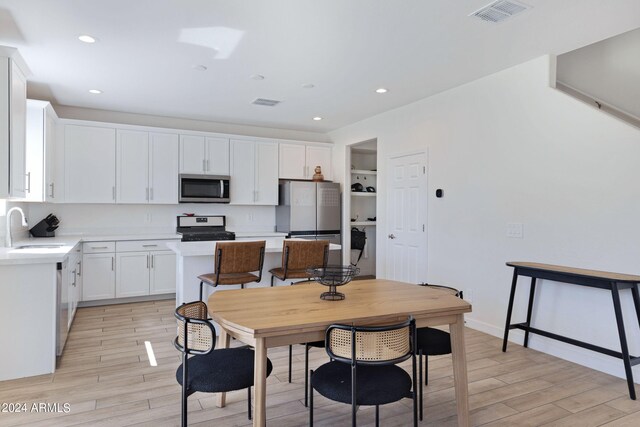 dining room featuring light hardwood / wood-style flooring and sink