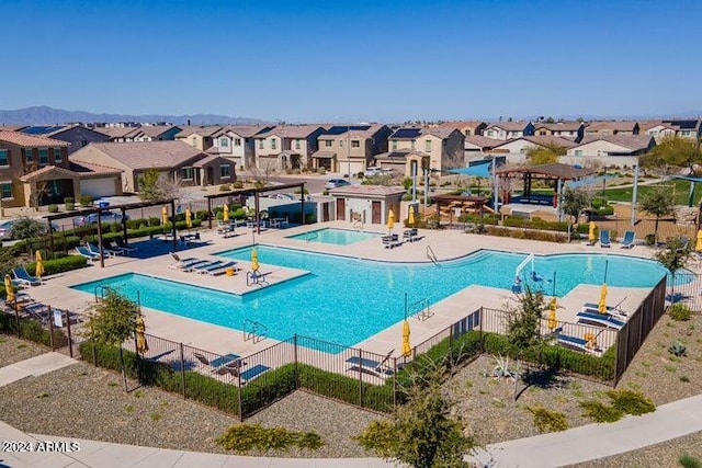 view of pool with a hot tub and a patio area