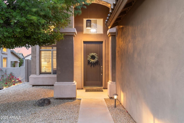 doorway to property with stucco siding