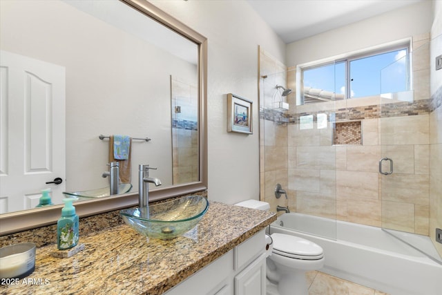 full bathroom featuring tile patterned floors, vanity, toilet, and enclosed tub / shower combo