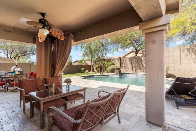 view of patio featuring a fenced backyard, a fenced in pool, outdoor dining space, and a ceiling fan