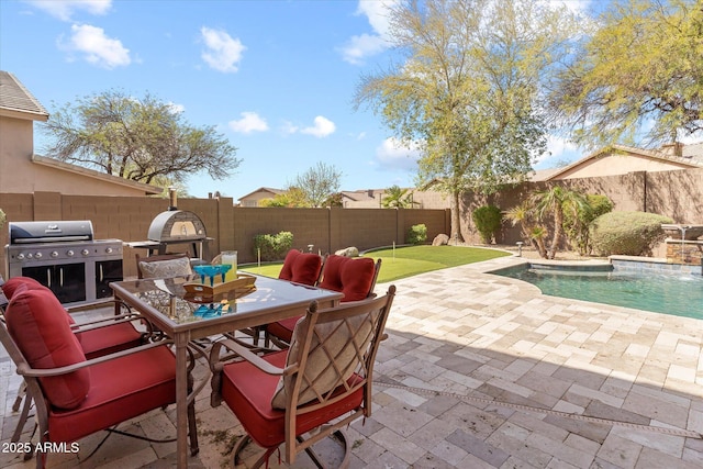 view of patio / terrace featuring outdoor dining area, a fenced backyard, a fenced in pool, and grilling area