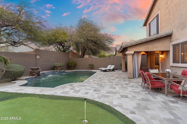 view of swimming pool with a patio, outdoor dining area, and a fenced backyard