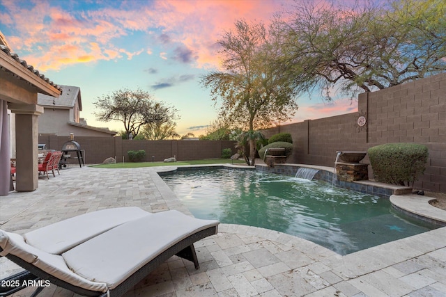 view of swimming pool featuring a fenced in pool, a fenced backyard, and a patio area