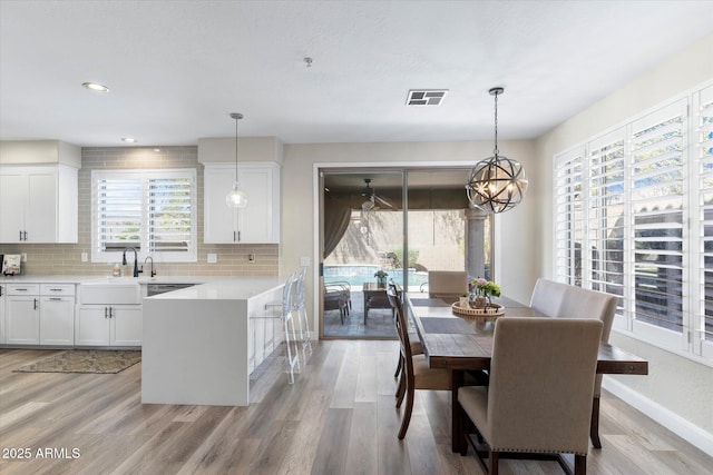 dining space featuring recessed lighting, baseboards, visible vents, and light wood-type flooring