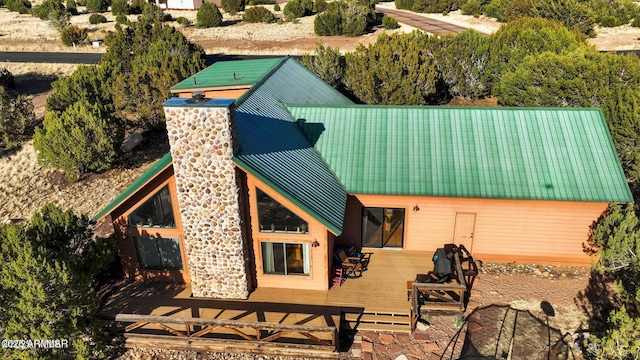 rear view of house with metal roof and a wooden deck