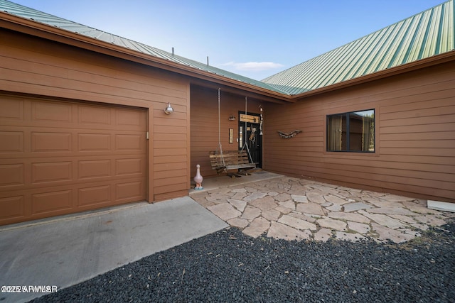 view of exterior entry featuring metal roof