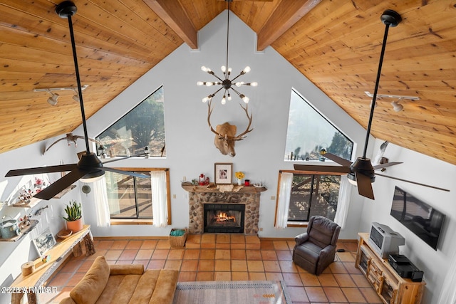 living room with track lighting, wood ceiling, ceiling fan with notable chandelier, and tile patterned floors