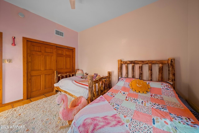 tiled bedroom featuring a ceiling fan and visible vents